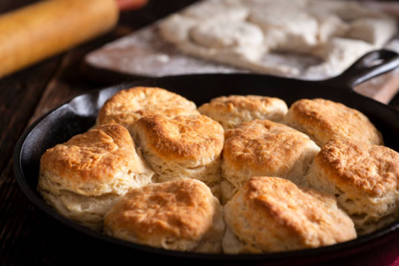 Perfectly baked buttermilk biscuits in a cast iron skillet.